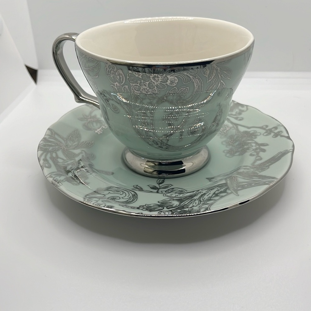 Silver and green tea cup and plate